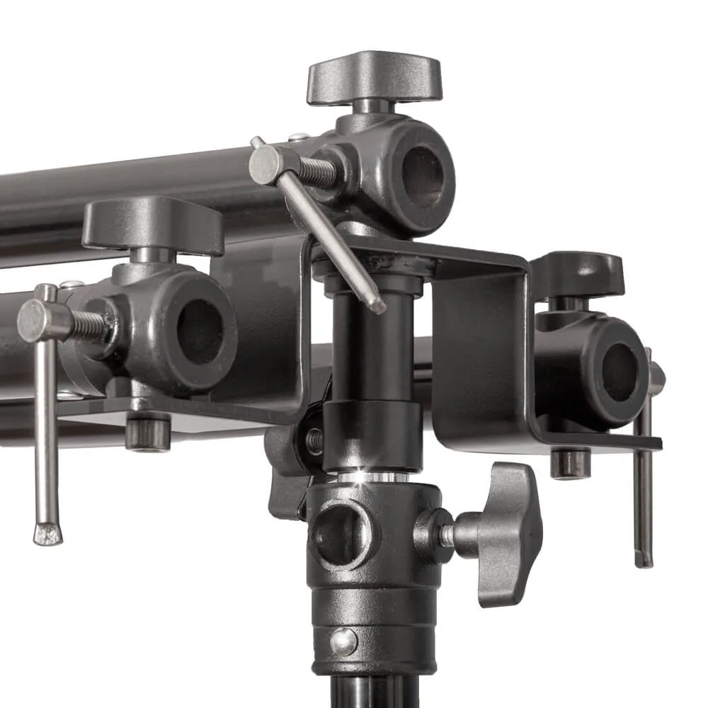 Close-up of a triple background stand head: three crossbar clamps on one upright, so three backdrops hang at once