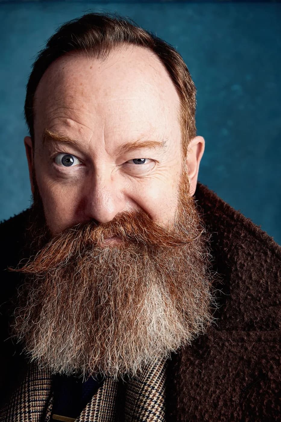 Portrait of Andy shot on a hand-painted backdrop in the studio